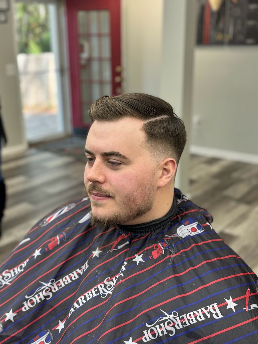 Classic side part with a fade and trimmed beard